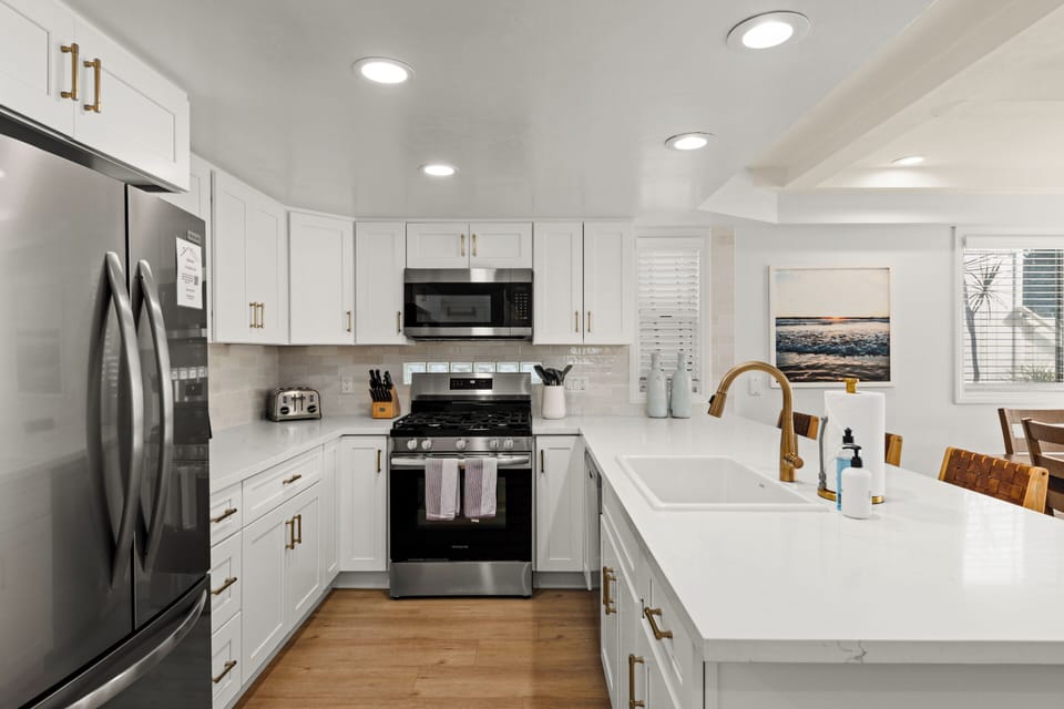 A fully equipped kitchen featuring sleek designer countertops, high-end appliances, and all essential utensils—providing everything you need for a comfortable stay.