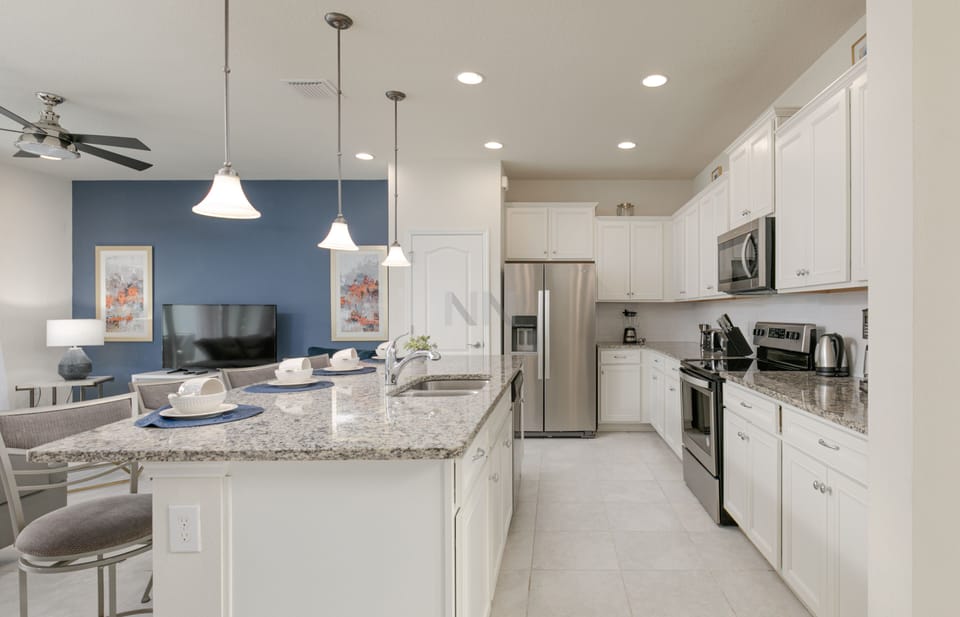 Wide view of the fully equipped, spacious, and well-lit kitchen.
