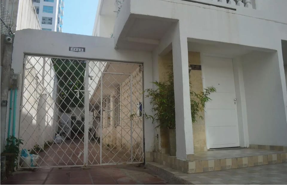 White fence entrance to the back where our properties are for your beach stay.