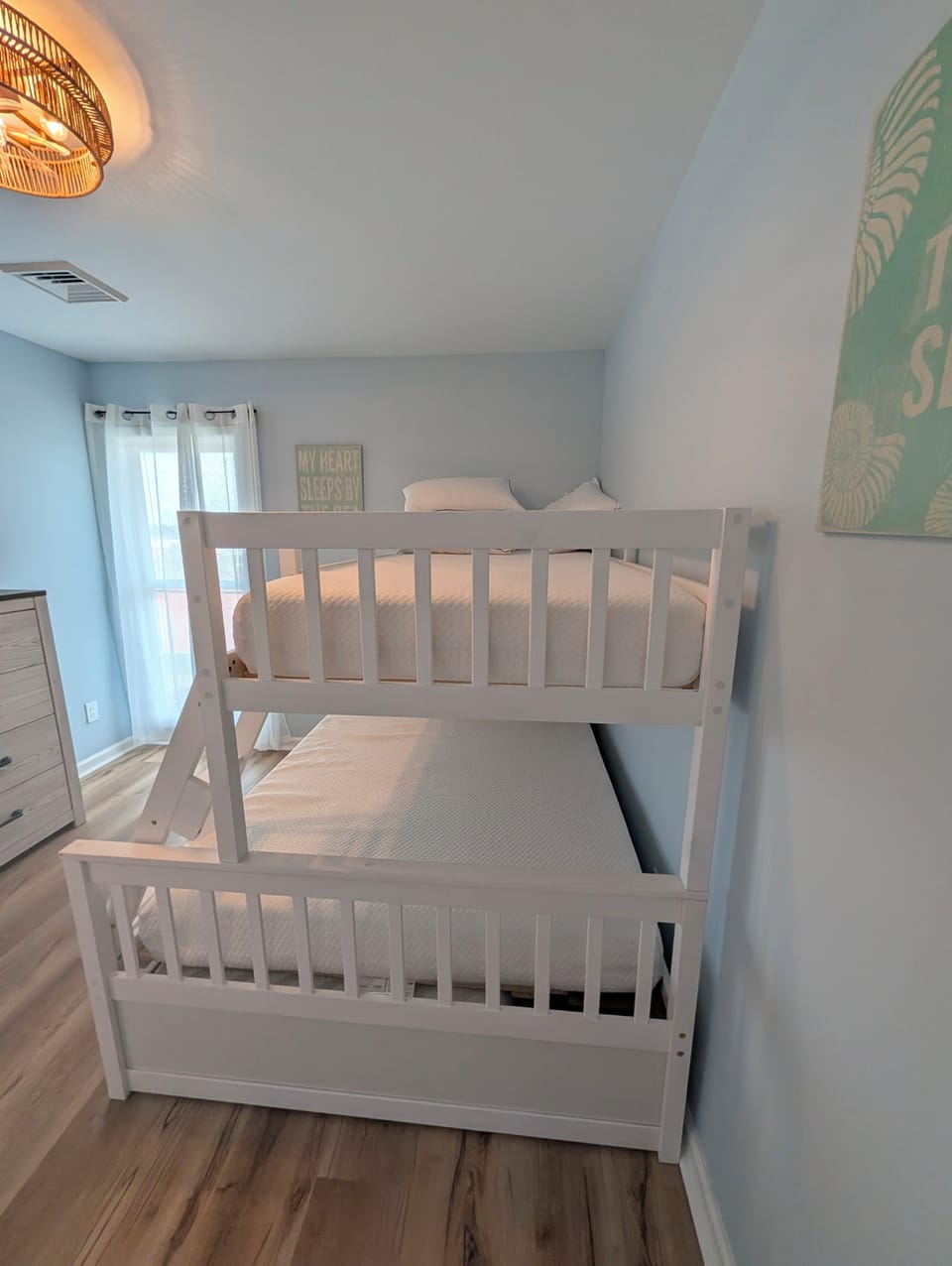 Your kids will love this coastal-themed bunk room, perfect for exciting bedtimes and cozy mornings with ample space for the whole family.