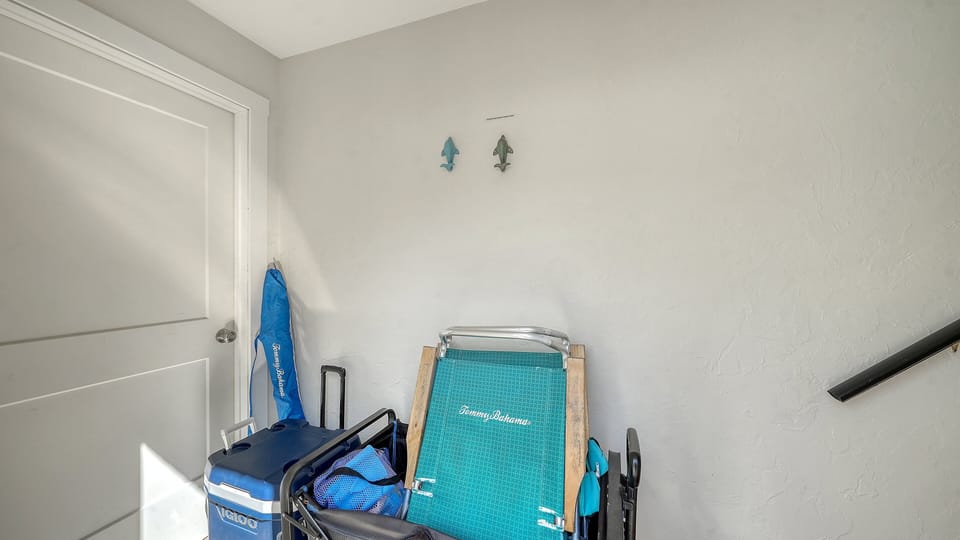 Convenient storage area with beach chairs, boogie board, and vacation essentials provided