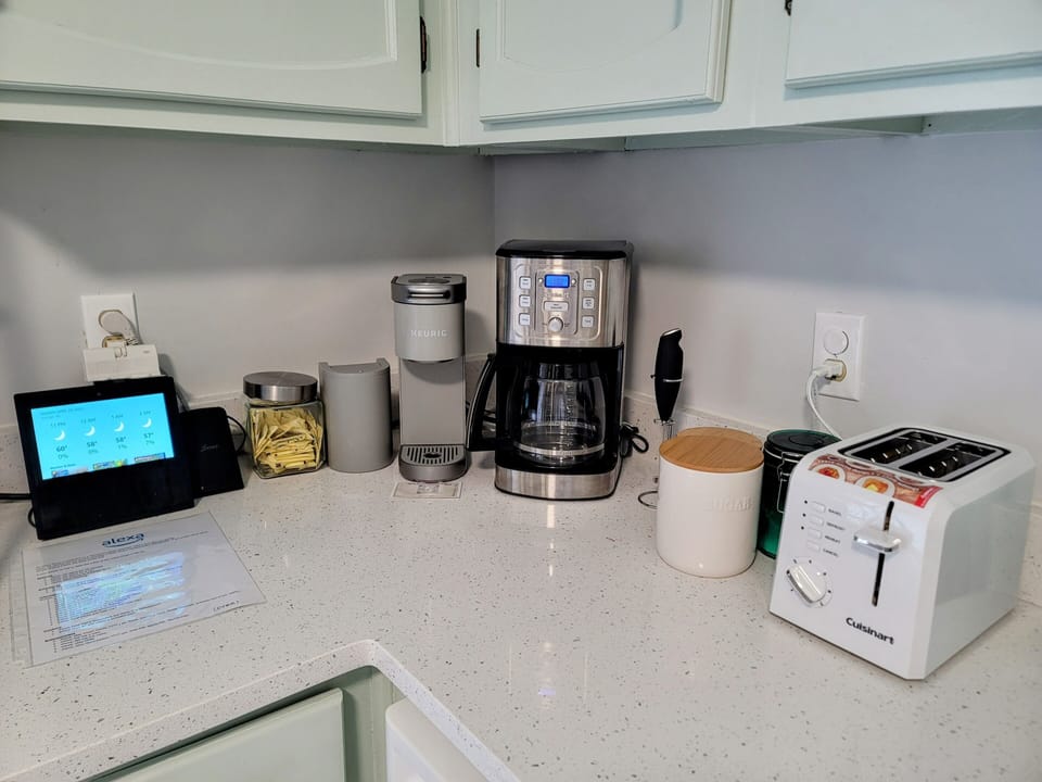 Coffee bar with Alexa, Keurig, electric whisker & wireless cell phone recharger.