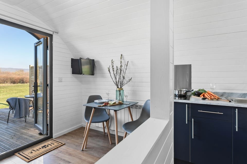 2 person dining area with dried flowers on -Bramley Glamping Pod