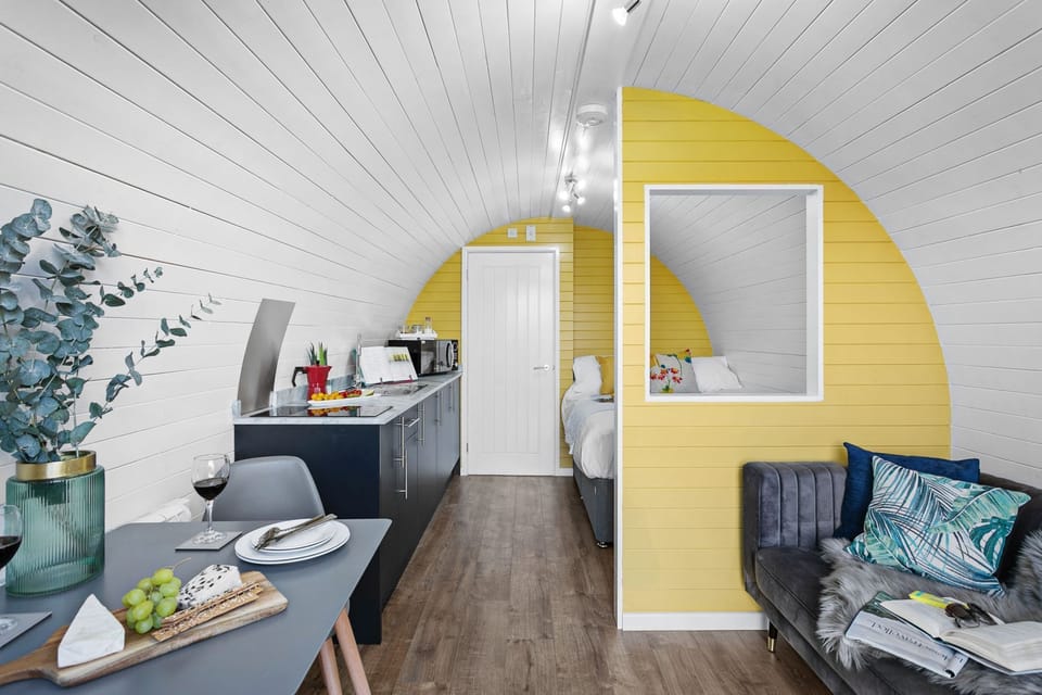 Living area at Morgan Sweet with dining area and sofa - Morgan Sweet Glamping