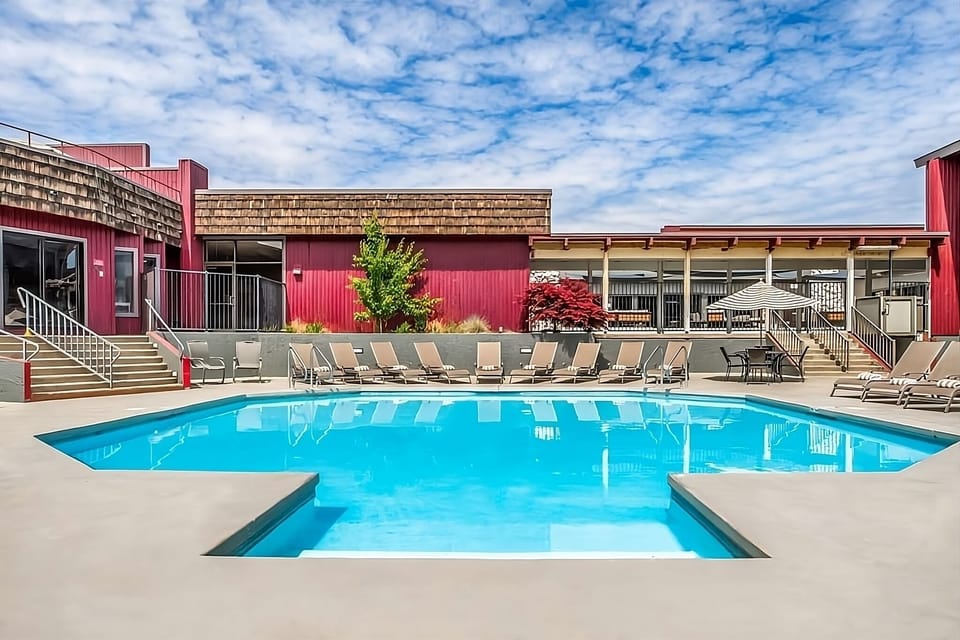 Dive into sunny relaxation with sparkling pool and loungers.