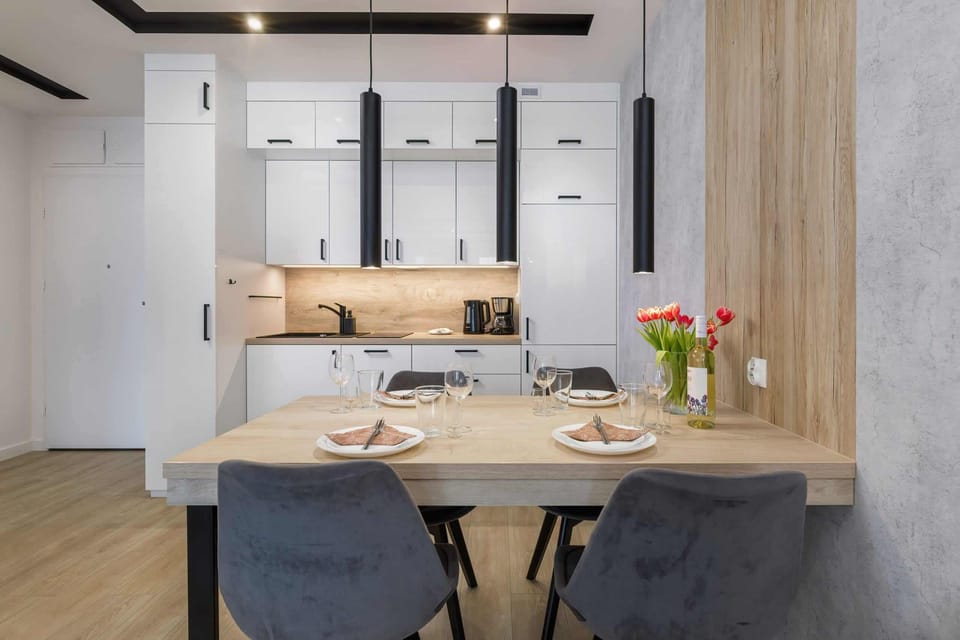 Dining area with stylish decor, featuring a wooden table and elegant chairs.
