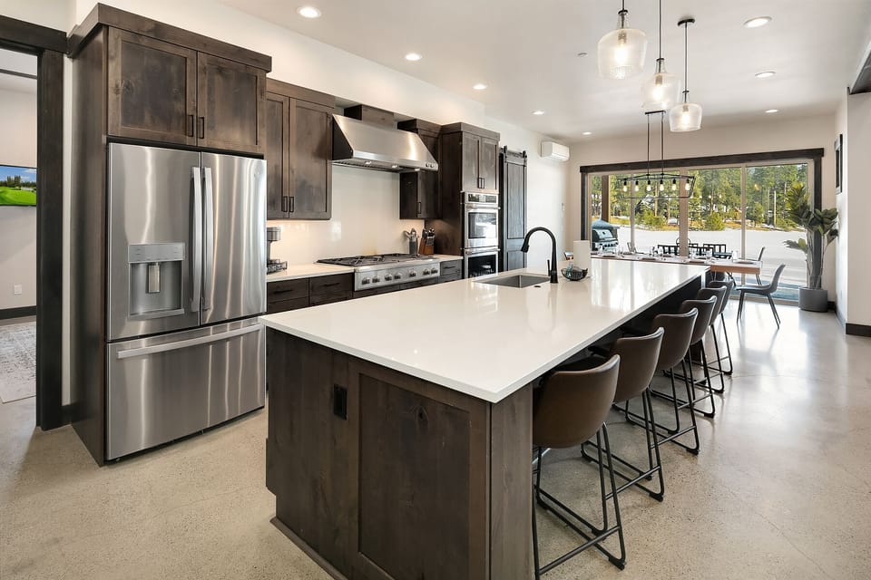 Knotty Pine: - Granite countertops in the large kitchen with the dining area in the background.