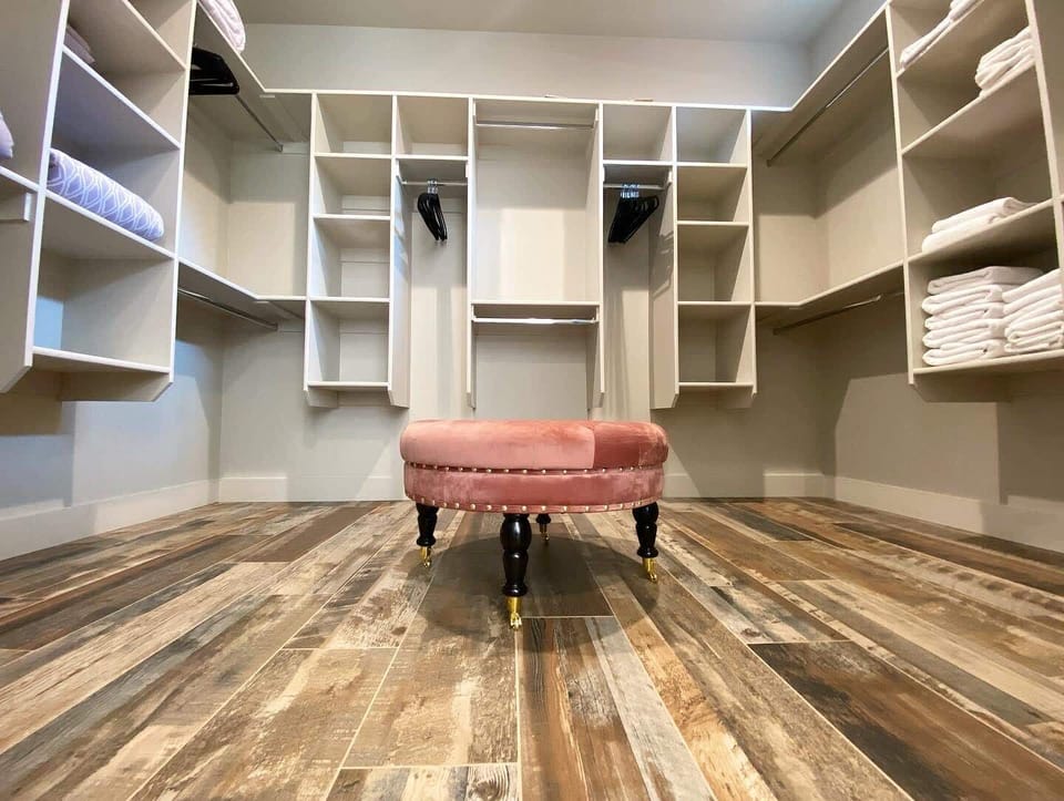 This luxurious closet has enough space for all of your clothes, and then some!