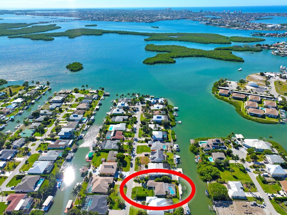 House located on Isles Of Capri. On the top left is Marco Island Bridge