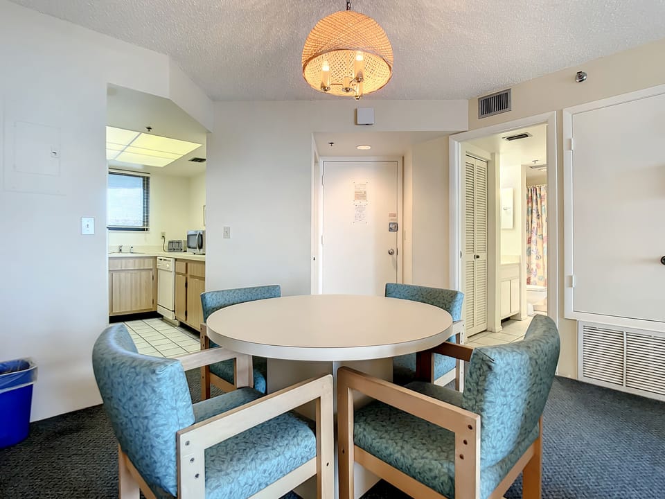 The dining room table has room for 4 guests.