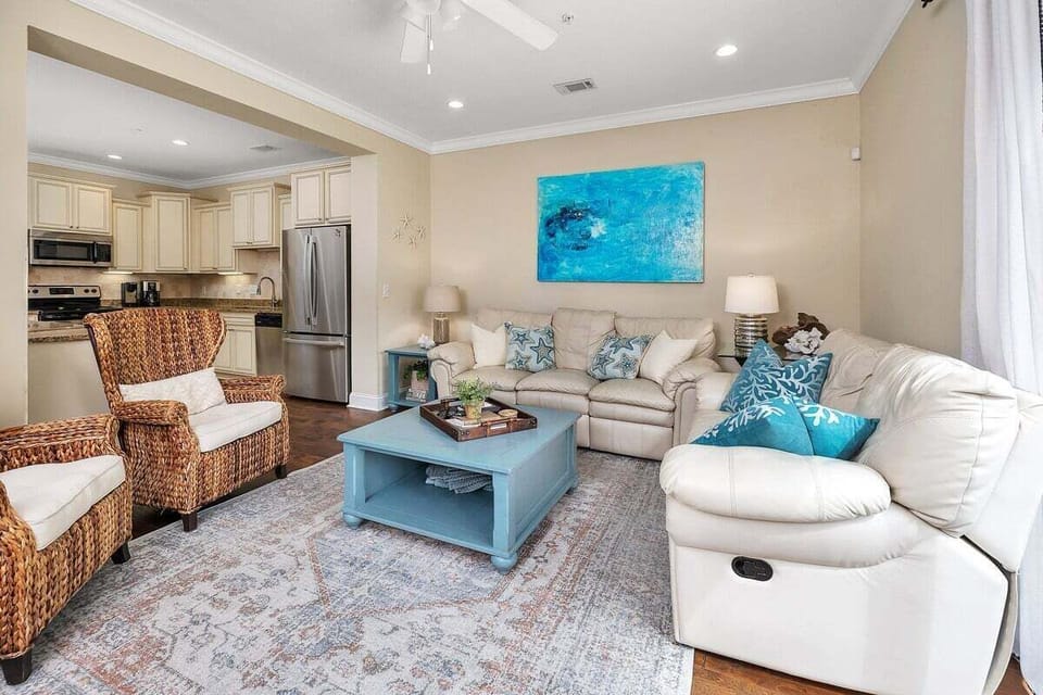 Living room with teal pillows, recliner, and open kitchen