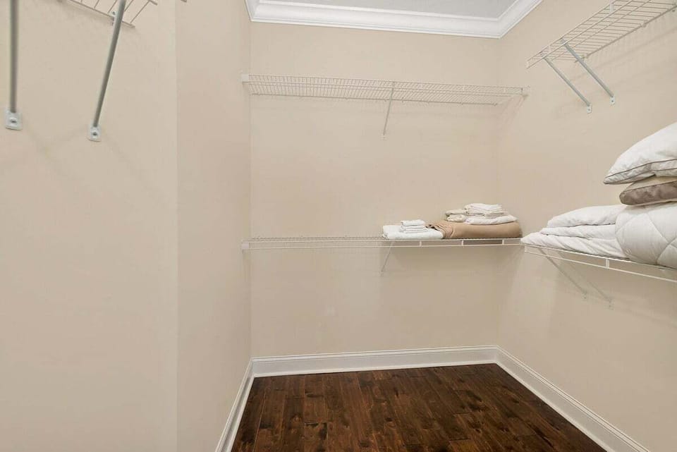 Walk-in closet with wire shelving and hardwood floors