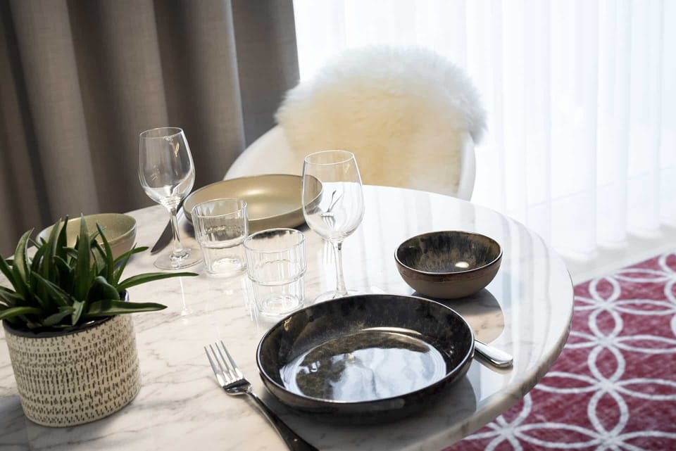 Savor slow breakfasts by the window at this cozy table.