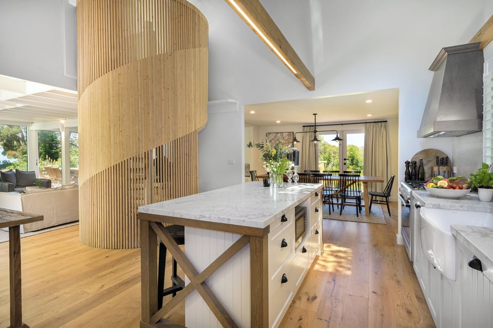 Well appointed contemporary farmhouse kitchen with adjoining dining/living areas