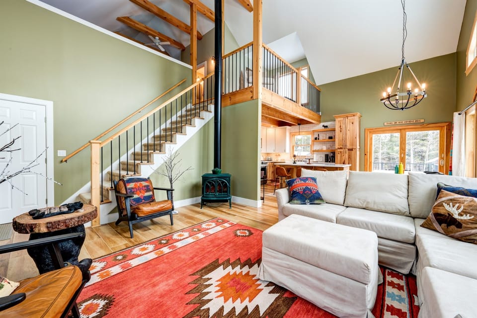 Living room looking into the dining and kitchen and up to the second-floor loft. 