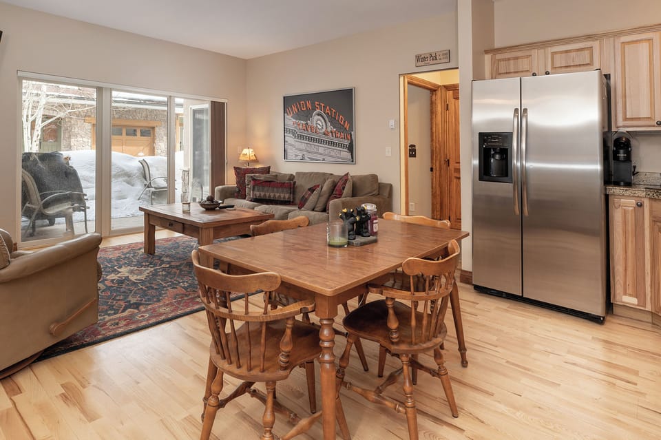 Unwind in this cozy open-plan space where your family can gather around the rustic dining table after winter adventures.