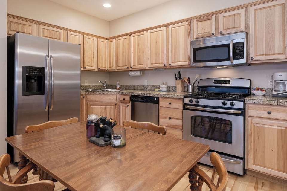 Prepare memorable meals in your fully equipped kitchen featuring stainless steel appliances, granite countertops, and ample cabinet storage.