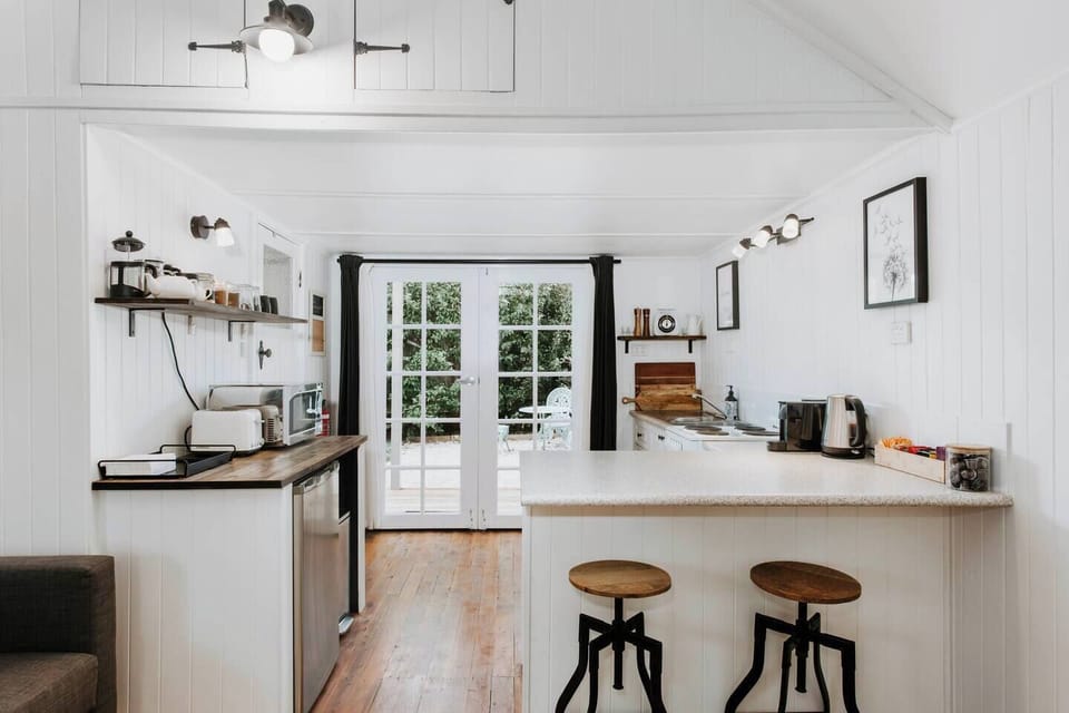 The studio is fully self-contained with a well-equipped kitchen and opens directly to the garden.

