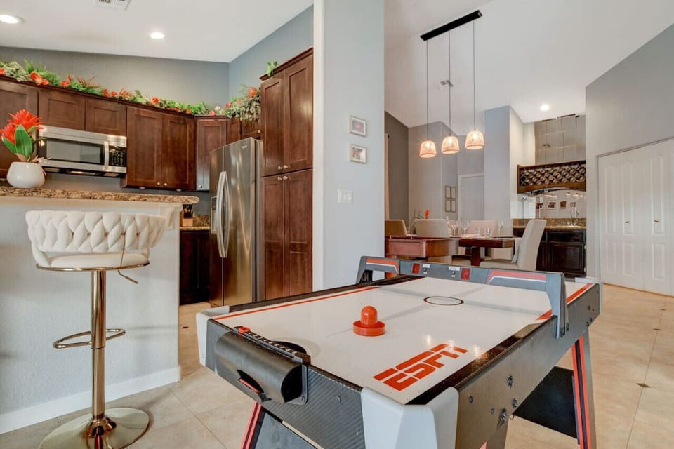 Our open-concept home is designed to entertain. Sit at the bar in our chef`s kitchen, play games, or have fun at our wet bar.