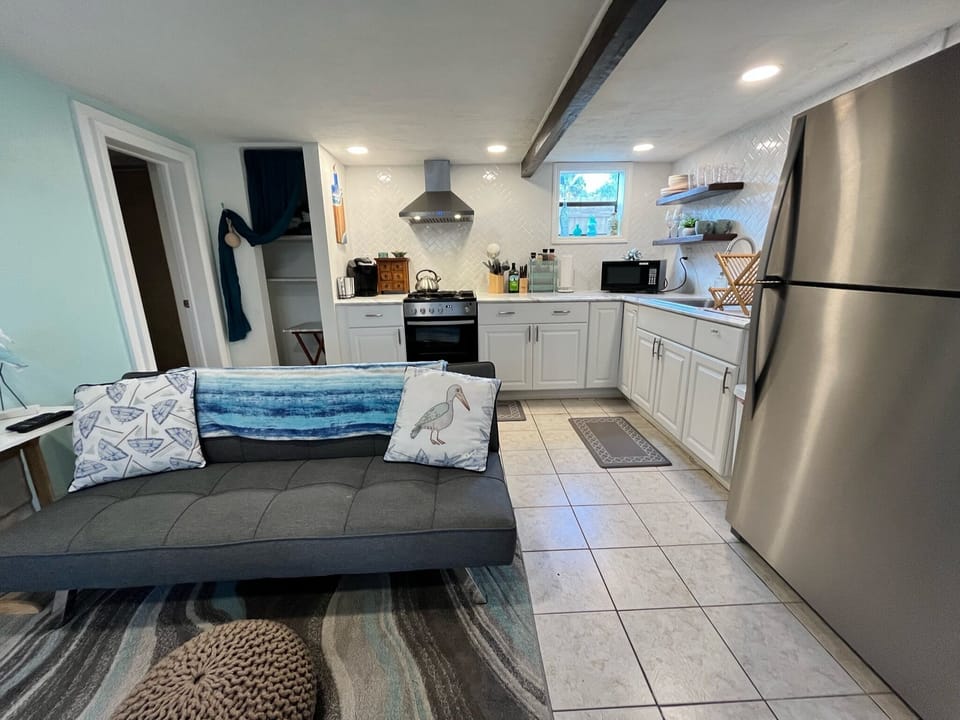 Open living room connected to the kitchen (note: futon folds to twin size bed)