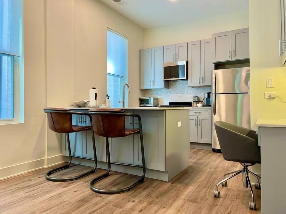 Plush RH counter stools overlook the fully-stocked kitchen, complete with a Keurig coffee station. 