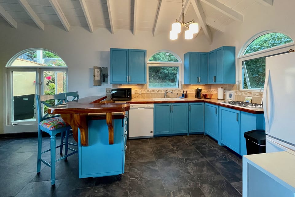 Comfy kitchen equipped with stove cooktop, toaster oven and microwave