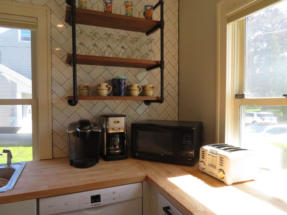 Fully equipped kitchen with cook wear, utensils, pots, pans, Keurig, toaster
