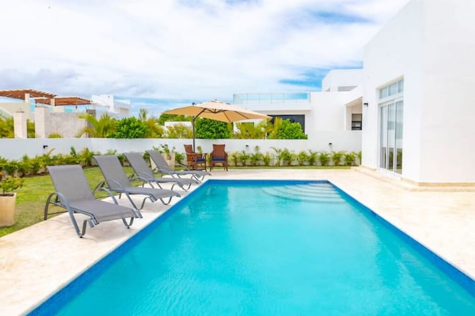 Private back-yard pool with lounge chairs.