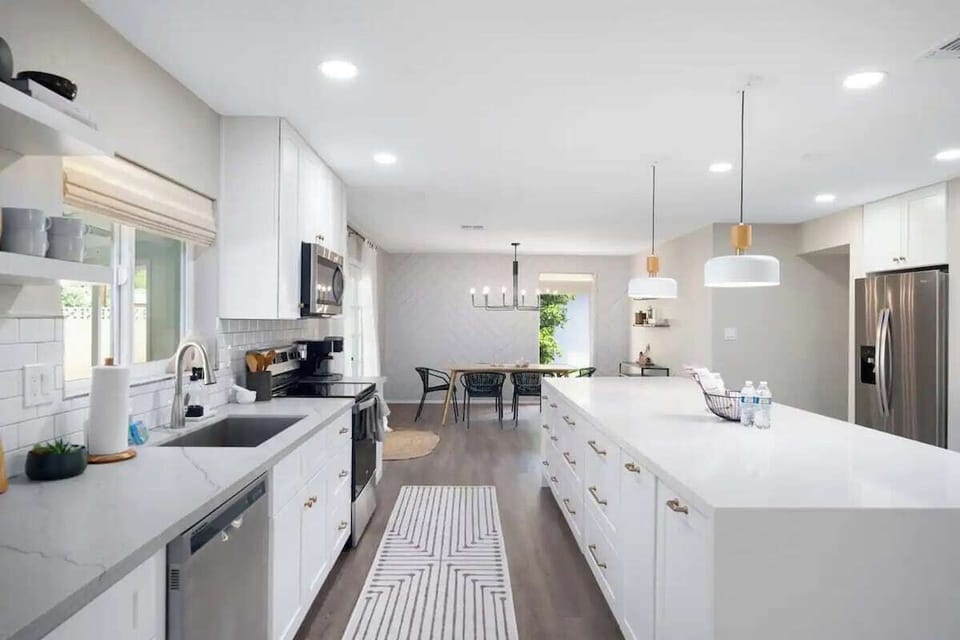The modern kitchen is fully-equipped for baking and meal preparations.