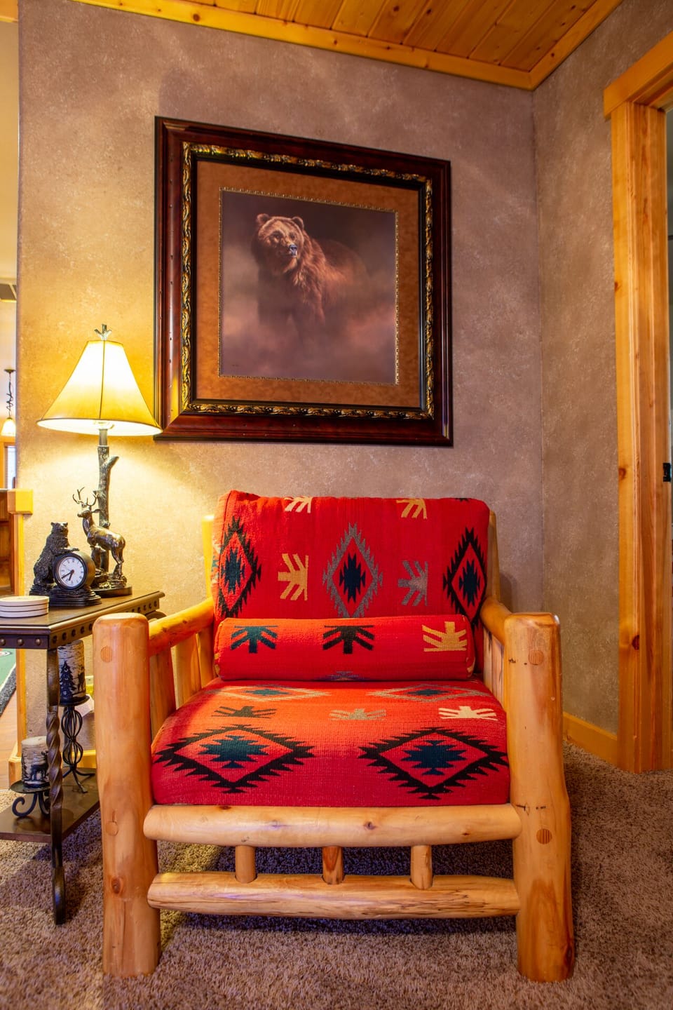 Red accent chair with bear portrait