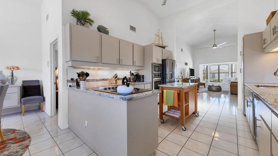 The kitchen is open to the multiple living spaces and dining room