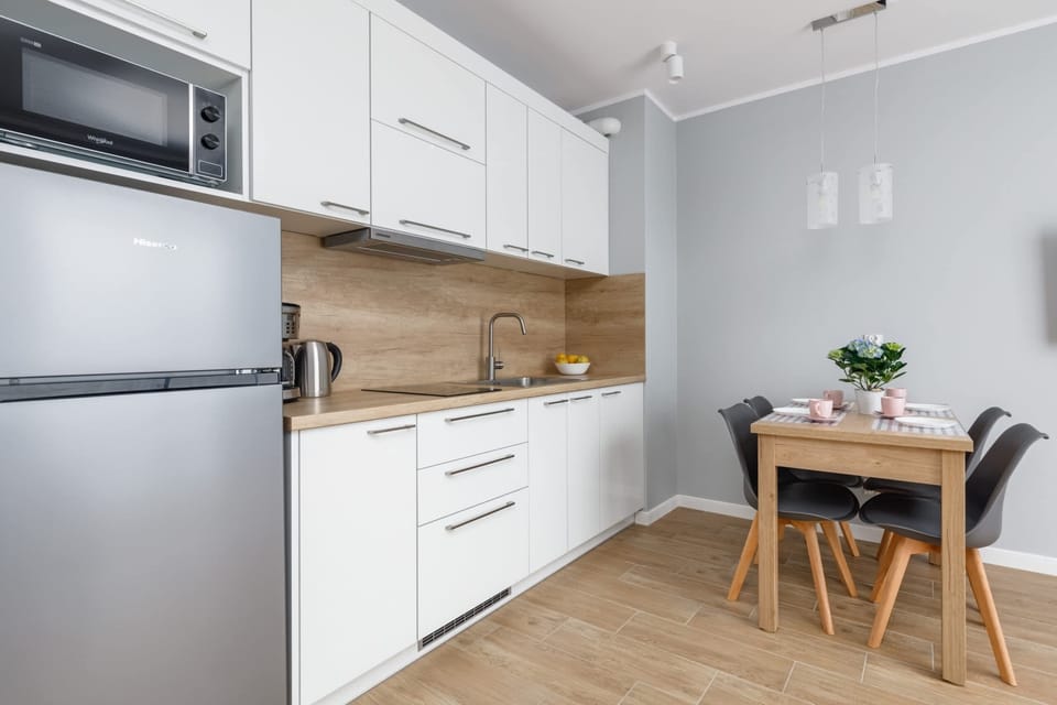 A kitchen with a dining nook, modern furniture, and decorative touches.
