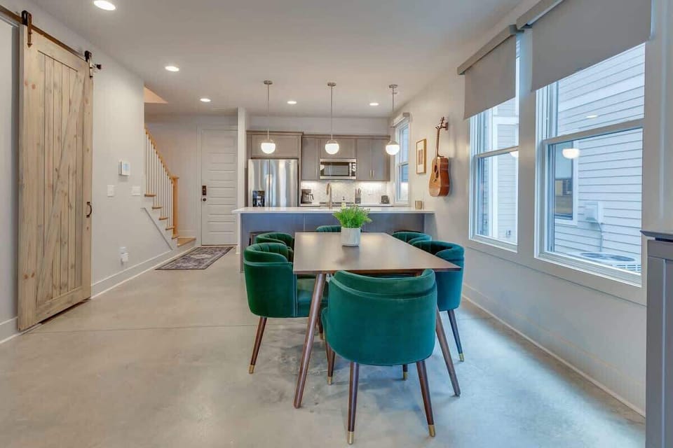 Both homes feature a stylish dining table and added bar seating at the kitchen counter. 