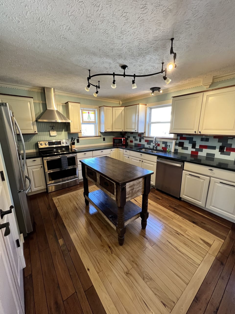 Fully stocked kitchen with electric stove/oven, dishwasher and fridge