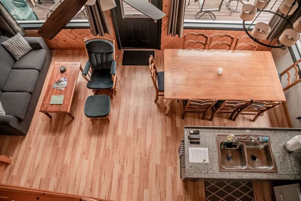 View of living room, dining area & part of kitchen from loft