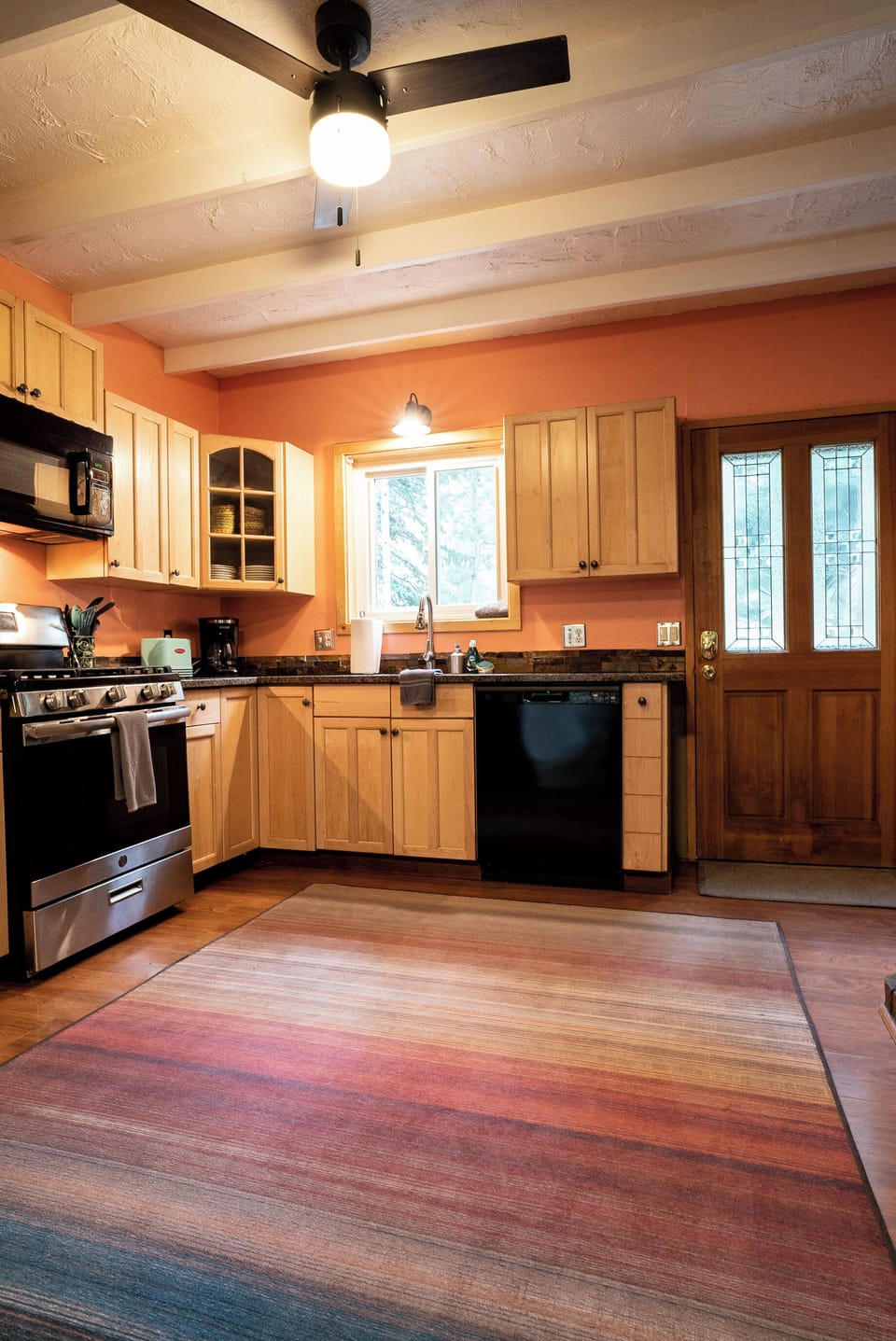 Open kitchen concept with dishwasher, gas stove & oven with microwave above