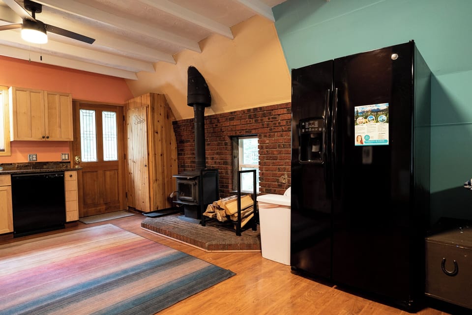 Full size fridge & Wood Stove in our open kitchen