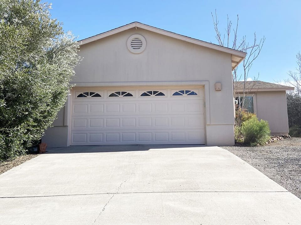 Front of house, private driveway to room is at right