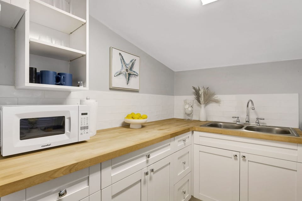 • Fully Equipped Kitchenette – Includes fridge, microwave, stovetop, coffee maker, and essential cookware