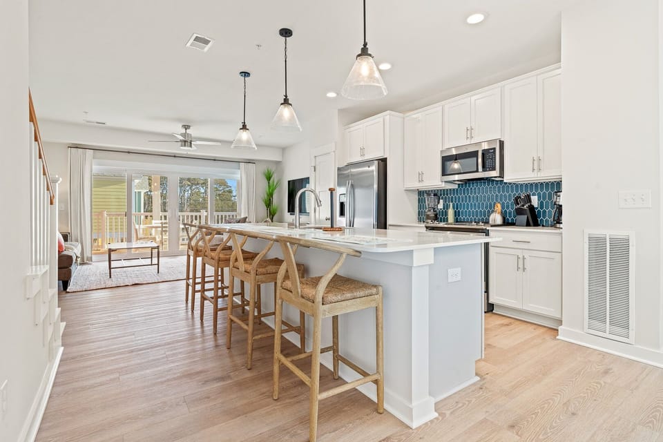 Kitchen with Bar Seating and Deck Access on Second Level