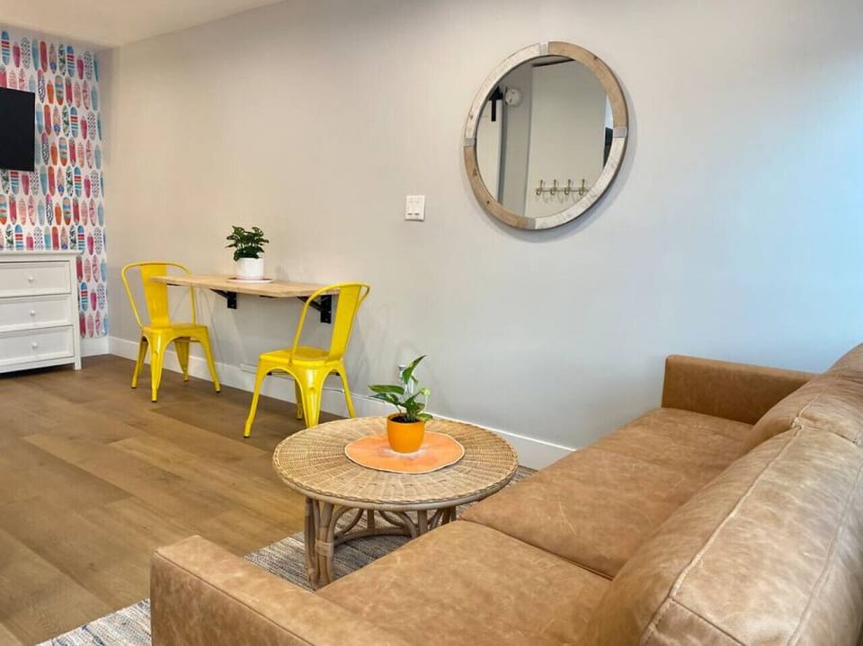 Living area with comfy leather couch and TV.