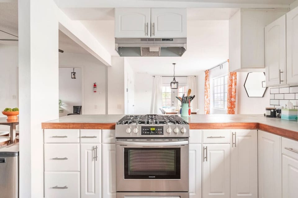 kitchen with updated appliances and wooden countertops.