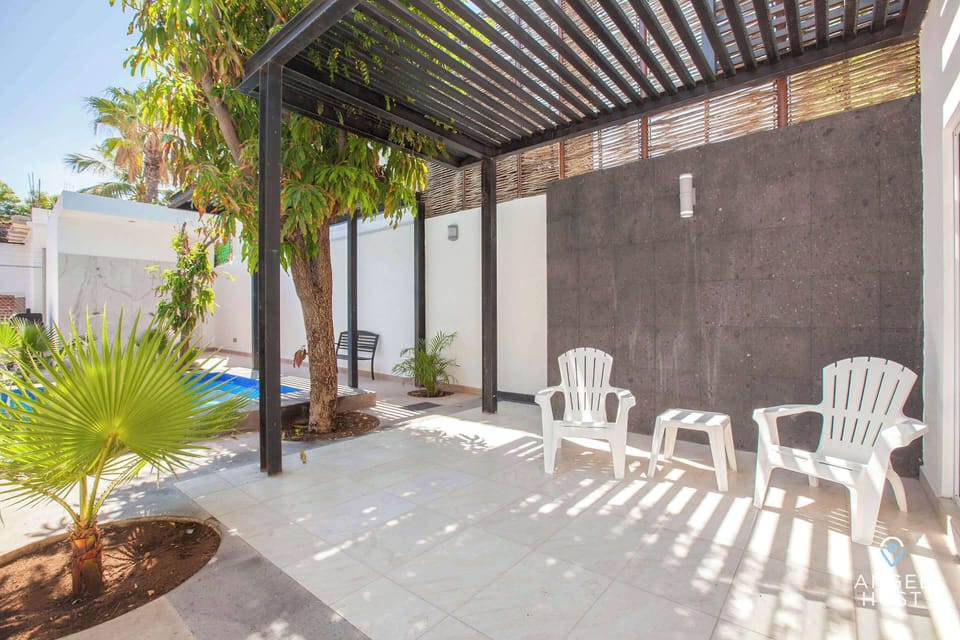 Covered outdoor sitting area near the pool.