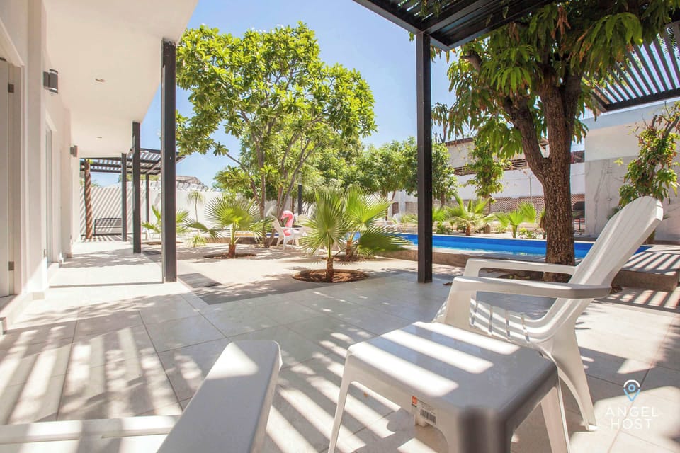 Lots of greenery surrounding the pool.