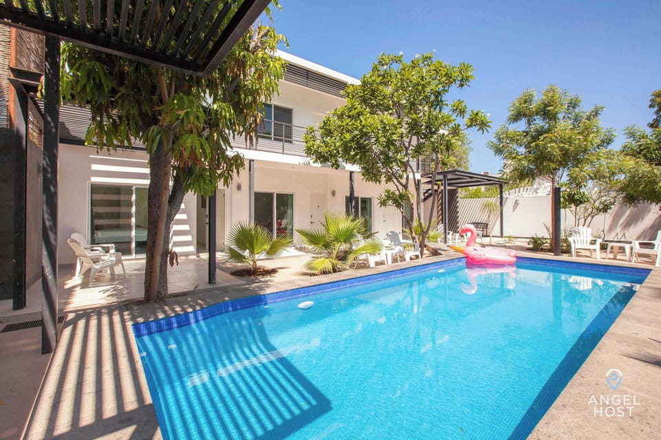 Shared pool surrounded by trees and greenery.