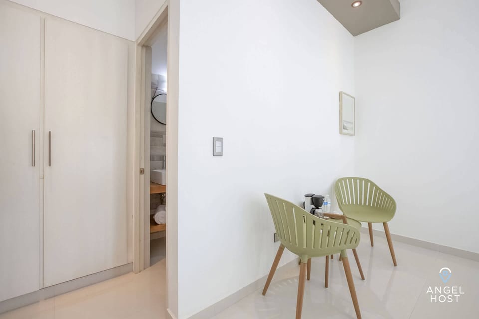 A small table nearby with 2 chairs to enjoy a meal or check email if needed