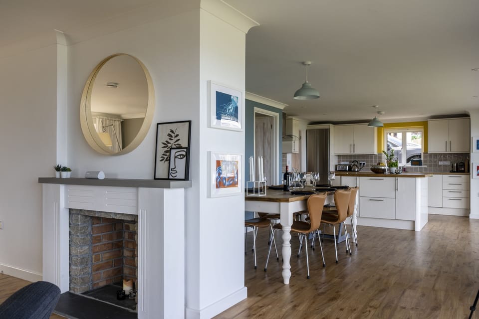 Lounge to dining and kitchen, with newly installed woodburner.