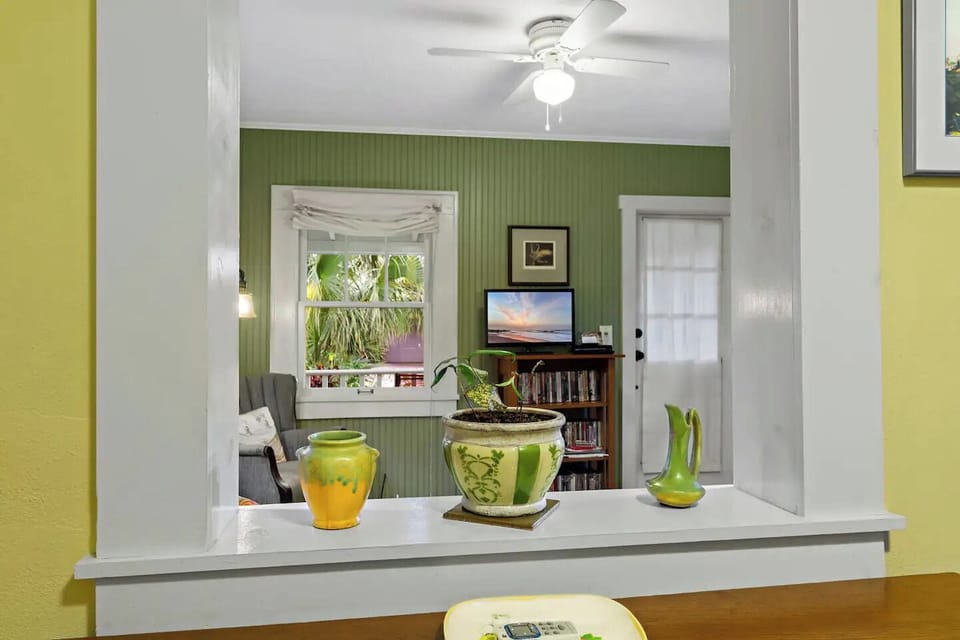 View of living room and front door from kitchen.