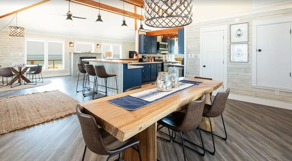 Long farm table with six seats available.