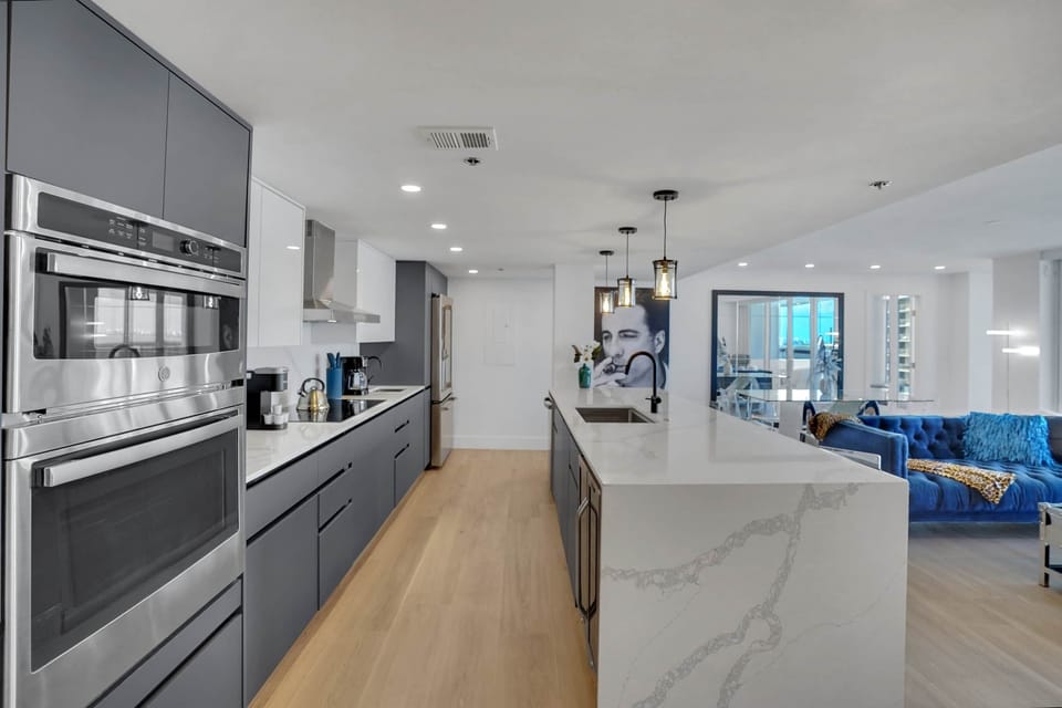Open concept fully equipped kitchen, Living area with balcony access
